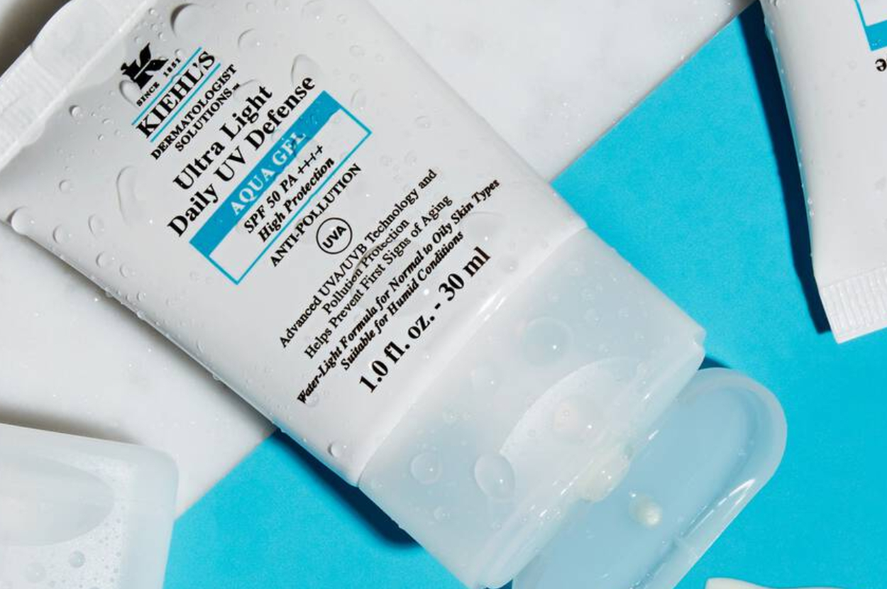 Tube of Kiehl’s Ultra Light Daily UV Defense Aqua Gel SPF 50 displayed on a blue surface