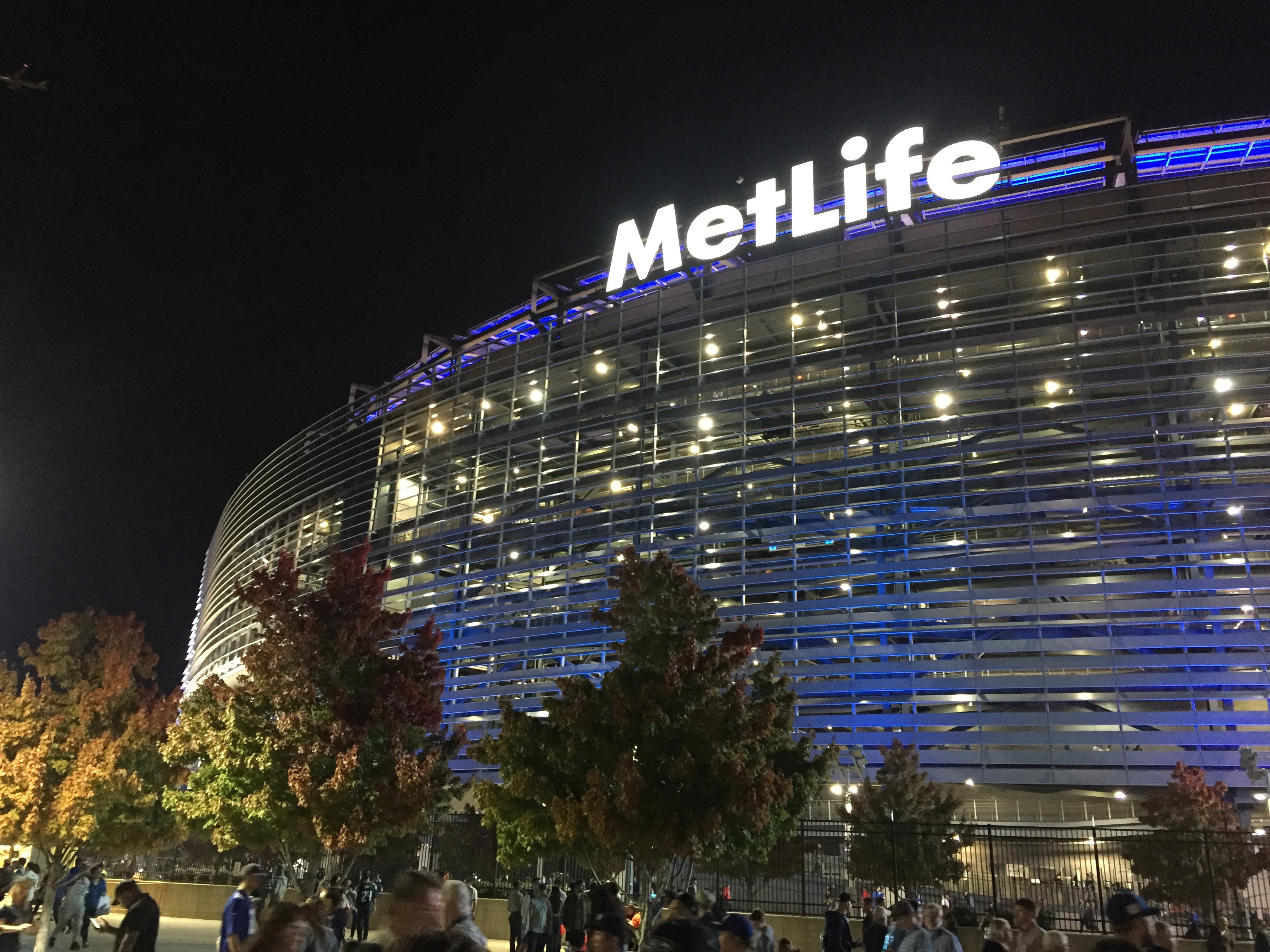 The exterior of MetLife Stadium lit up at night