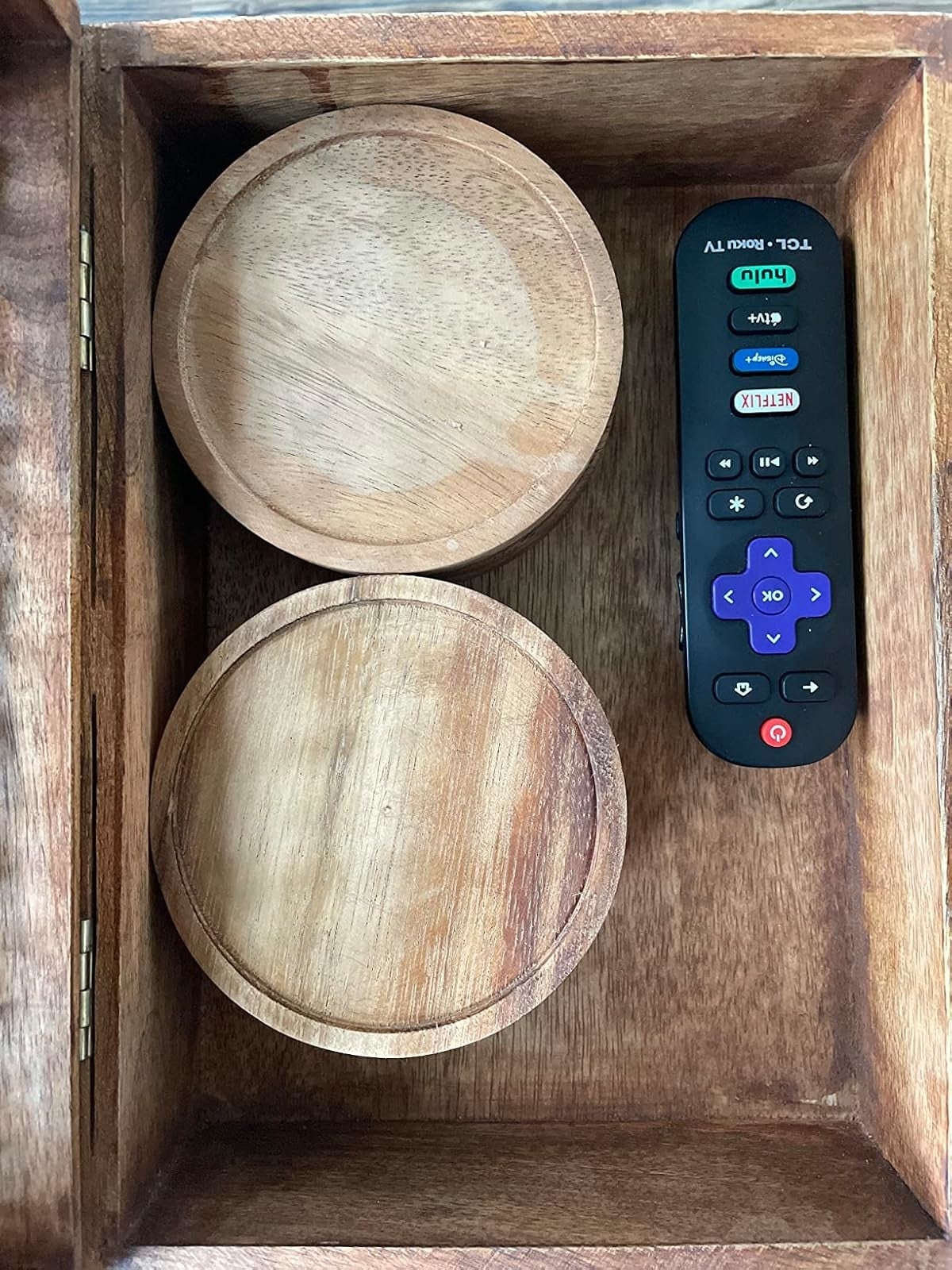 reviewer's wooden box contains two coaster holders and a Roku TV remote