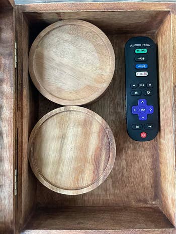 reviewer's wooden box contains two coaster holders and a Roku TV remote