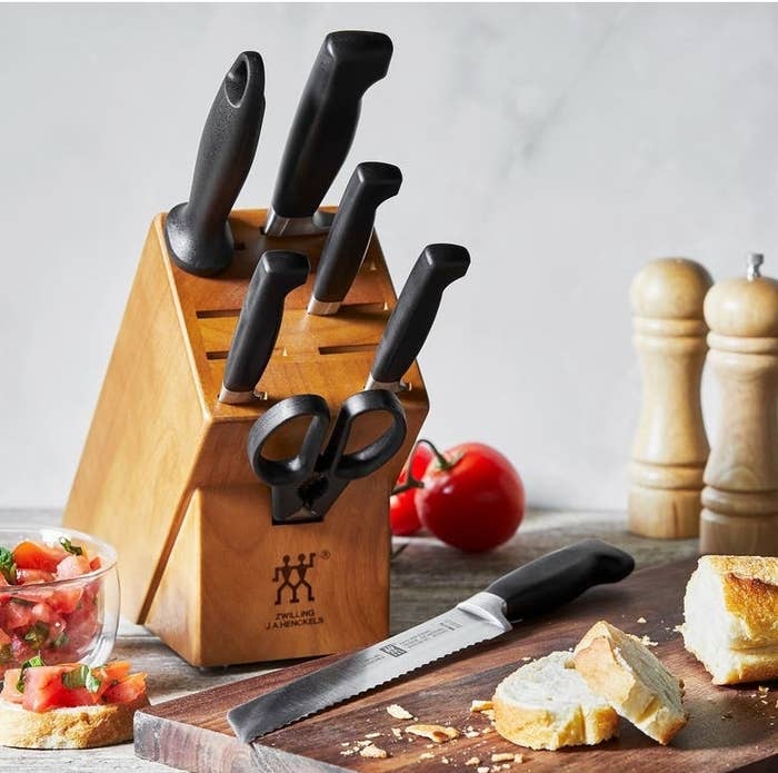 Knife artifact acceptable with respective knives, scissors, a breadstuff knife, and a woody cutting committee with sliced breadstuff and a tiny vessel of salsa