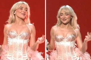 Person in a glamorous corset dress with feather details, holding a microphone and smiling on stage