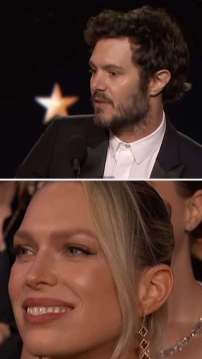 Two people at an award ceremony. One is speaking at a podium in a suit. The other is in the audience, smiling, with elegant earrings