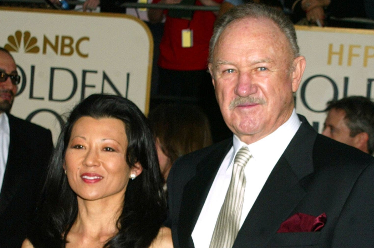 Two people attending a formal event, one in a sleek gown and the other in a suit with a pocket square, on a red carpet at the Golden Globes