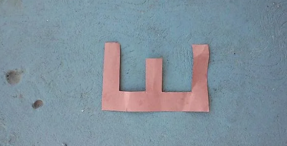 Paper cutout shaped similar  the missive  "W" placed connected  a textured surface
