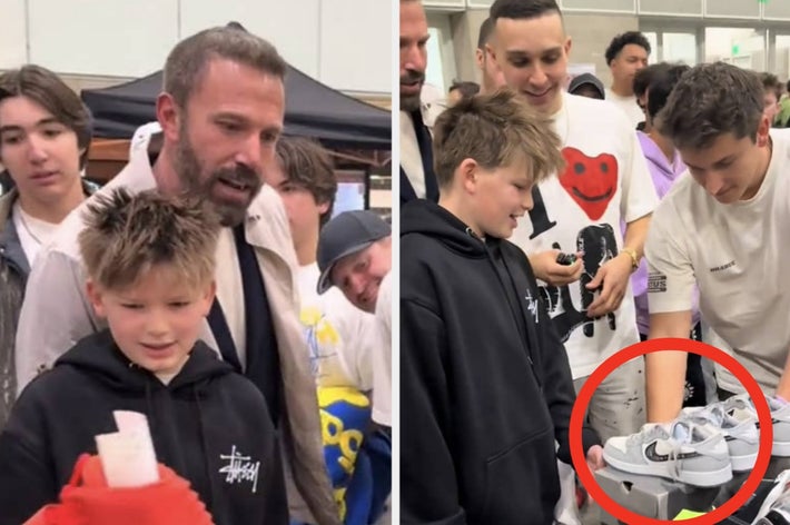 Group of people, including a man in a casual jacket, engaging with kids at a sneaker event. The man looks at a boy holding a custom sneaker