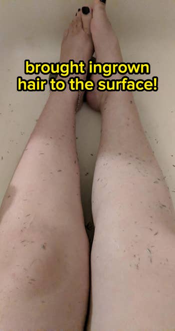 Close-up of legs in a bathtub with shaved hair visible on the skin, showcasing a recent shaving experience