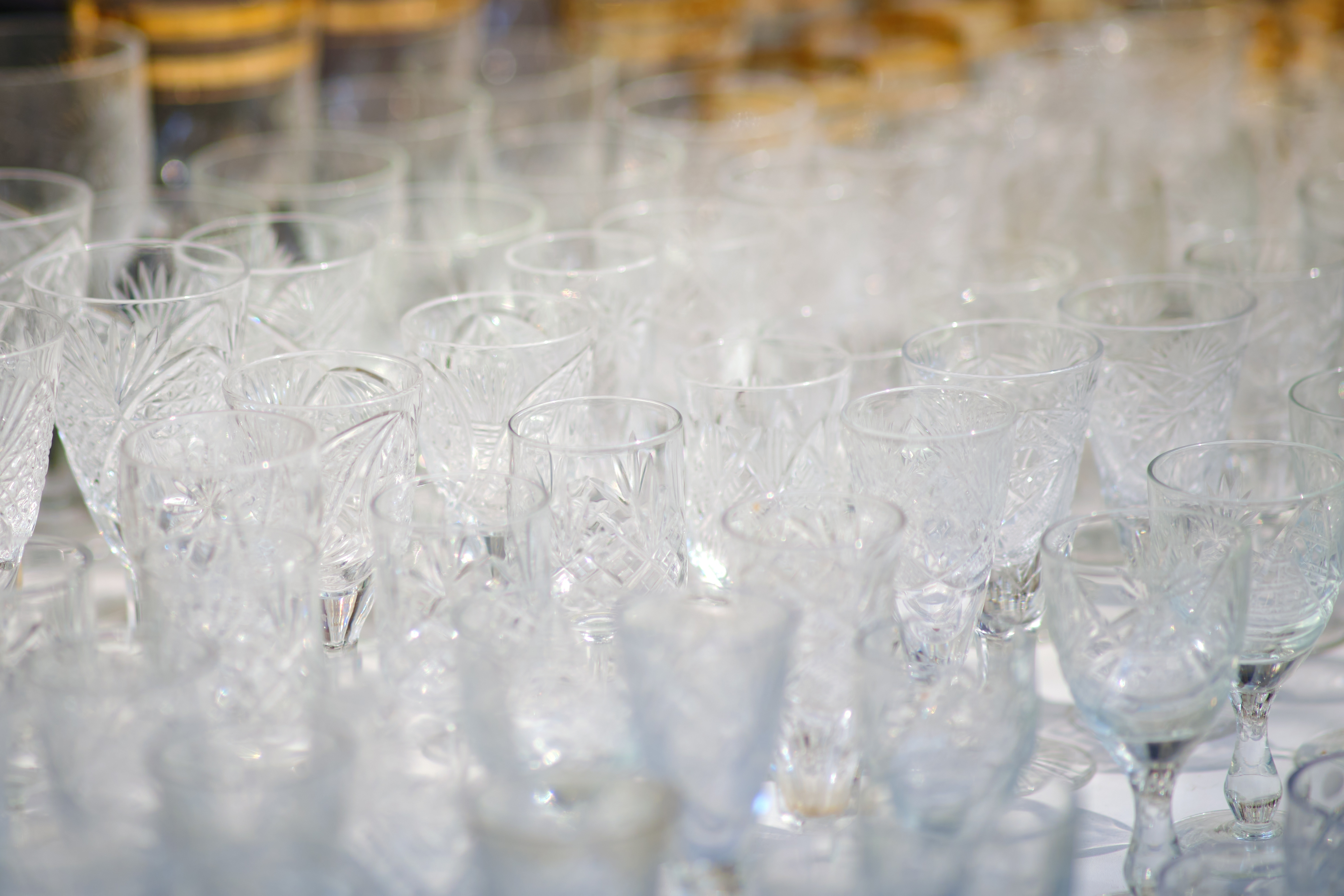 Close-up of numerous clear glassware items, showcasing various shapes and intricate designs
