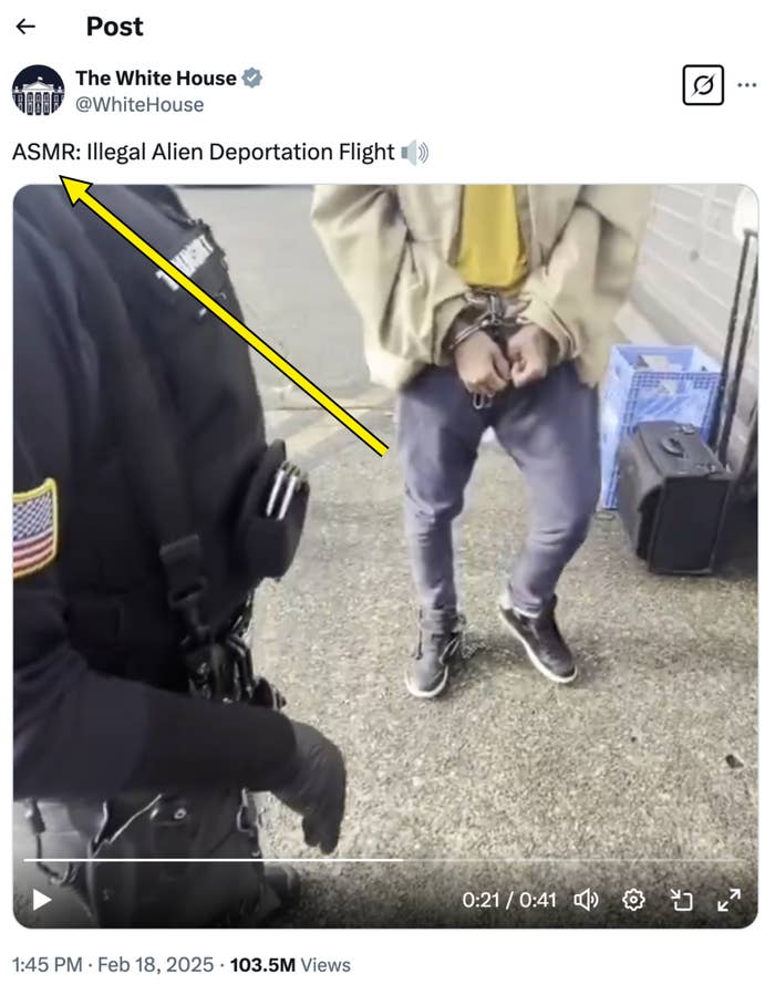 A person wearing handcuffs and ankle shackles is escorted by an officer. The scene suggests a detention or arrest situation