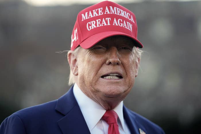 Person wearing a "Make America Great Again" hat, showing a neutral expression