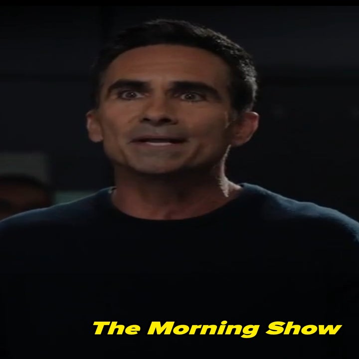 Yonko from The Morning Show in a dark sweater speaks passionately with an expressive facial expression indoors