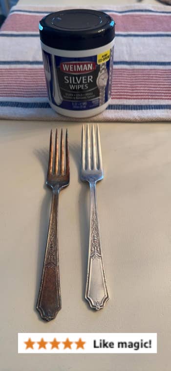 Two forks, 1  tarnished and 1  polished, are placed successful  beforehand   of a instrumentality  of metallic  wipes connected  a table