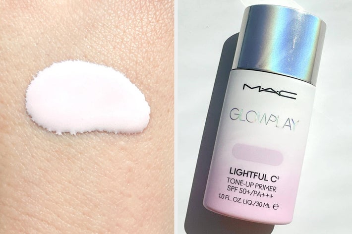 Hand holding a swatch of MAC Glow Play Lightful C Tone-Up Primer, with the product bottle beside it