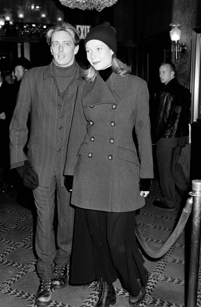 Donovan Leitch and Gwyneth Paltrow in stylish winter coats and gloves pose together, at a formal event