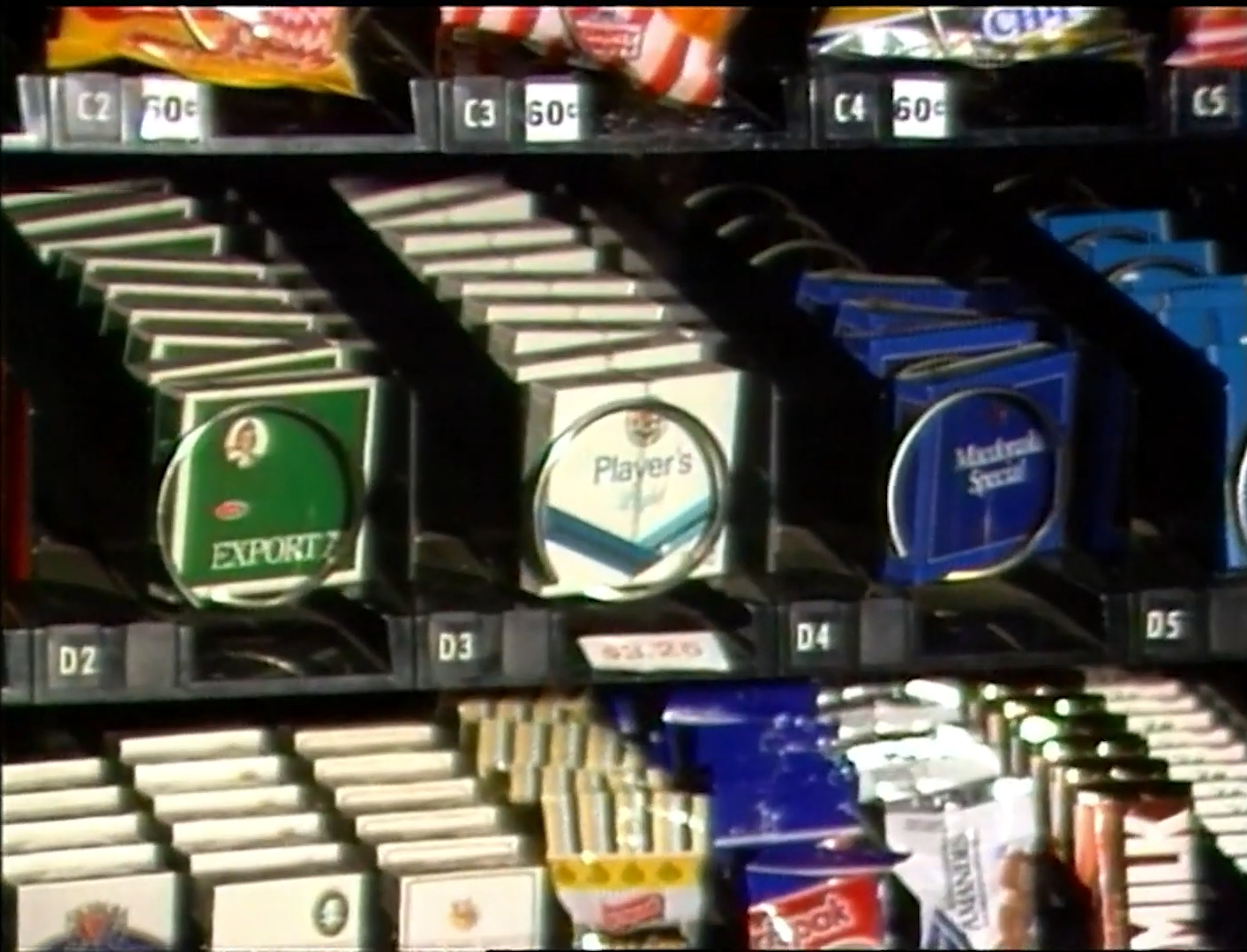 Vintage cigarette vending machine with various brand packages displayed in rows