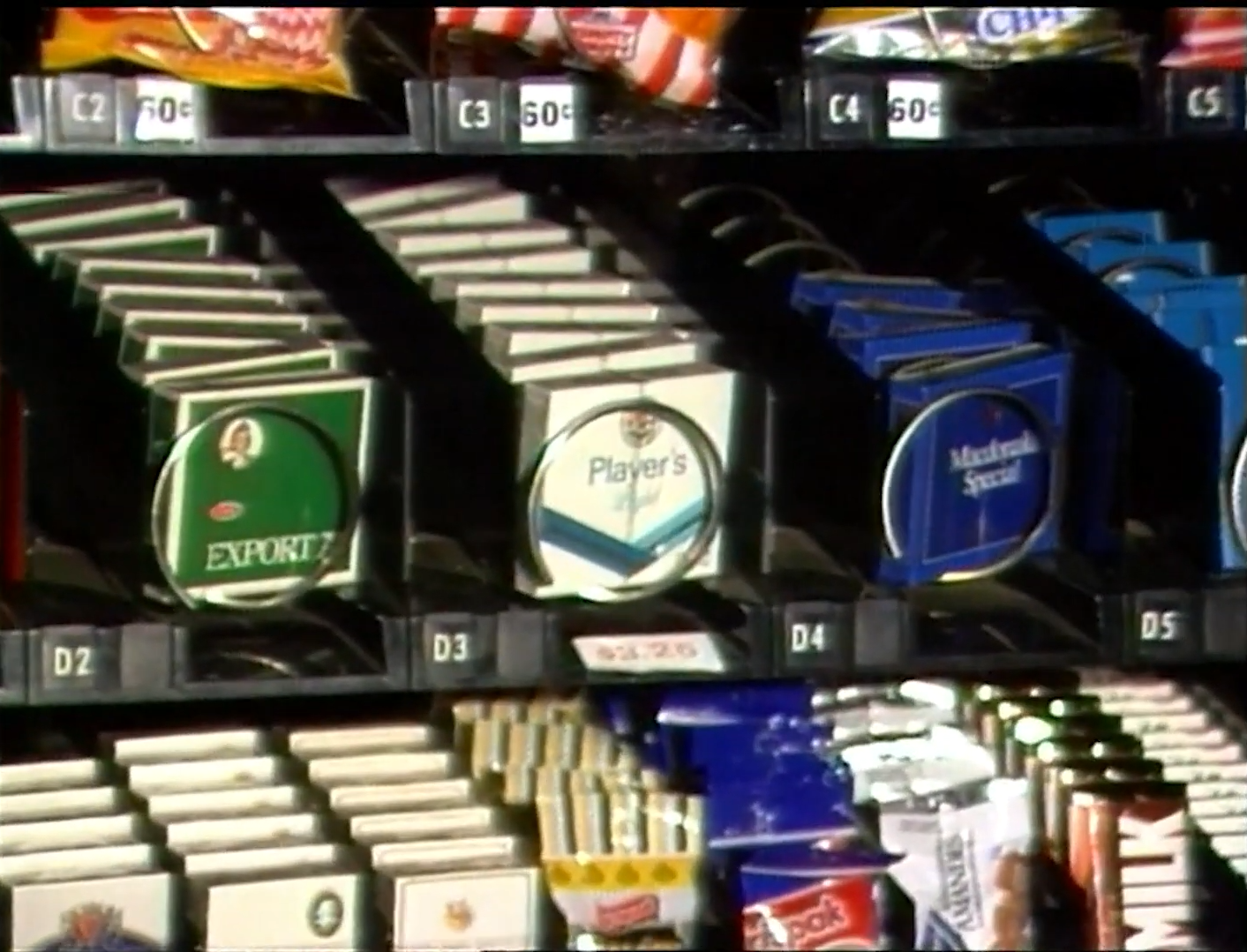 Vintage cigarette vending machine with various brand packages displayed in rows