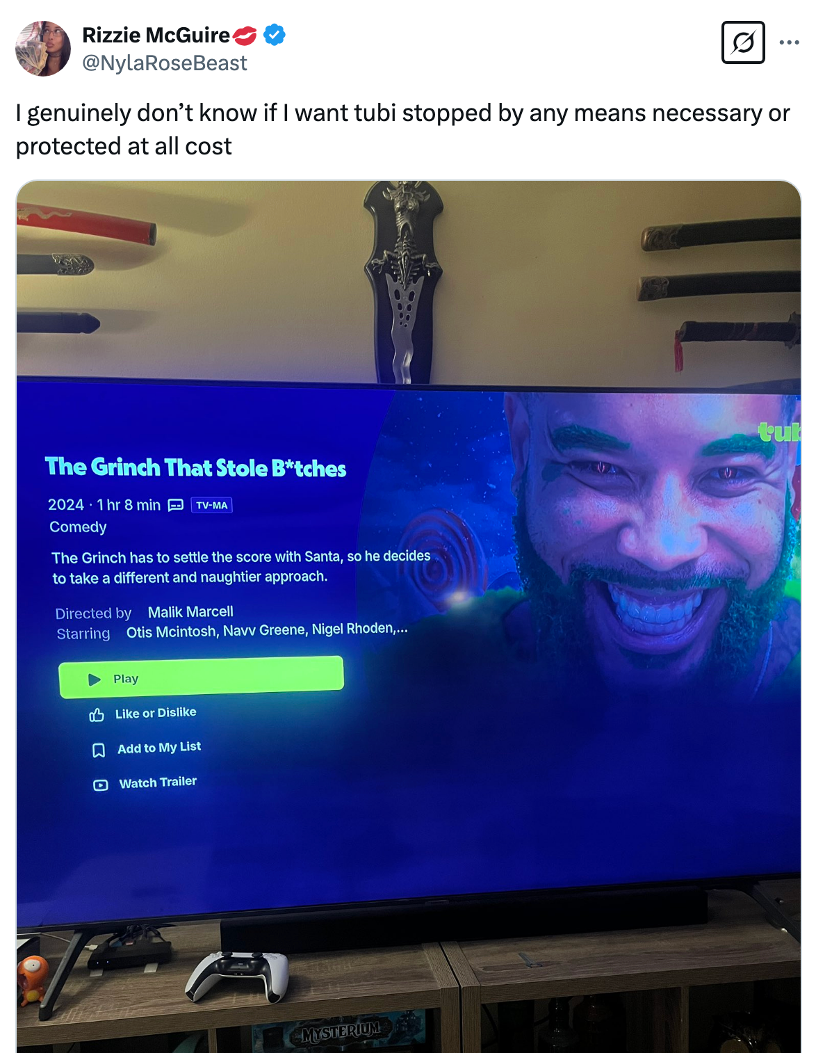 TV screen displaying "The Grinch That Stole B**ches," a comedy scheduled for 2024. Troll tweet above questioning the Grinch character