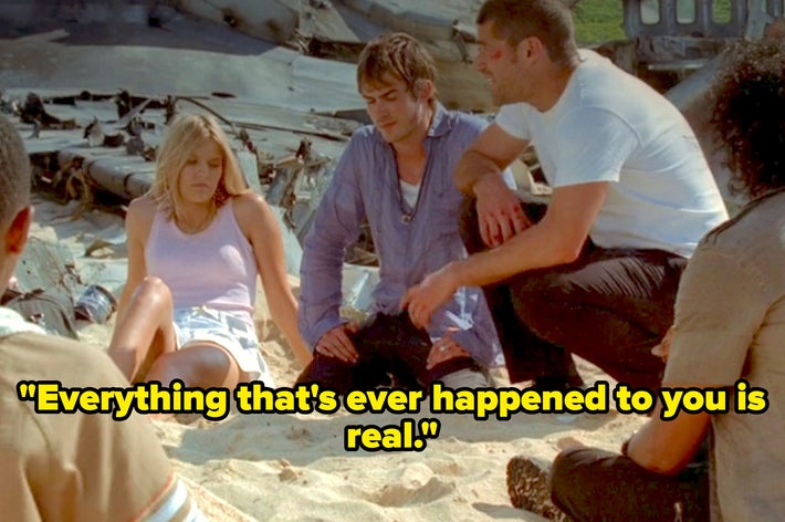 Three people sit on a beach near a plane wreck; one is speaking, saying, "Everything that's ever happened to you is real."