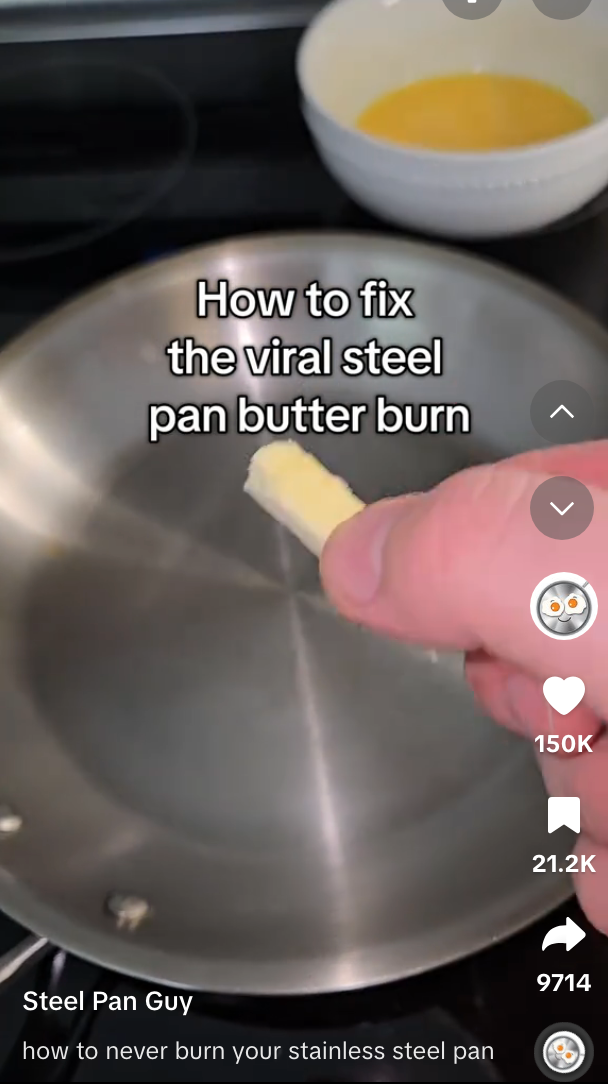 Person holding a small piece of butter over a stainless steel pan with text: &quot;How to fix the viral steel pan butter burn.&quot;