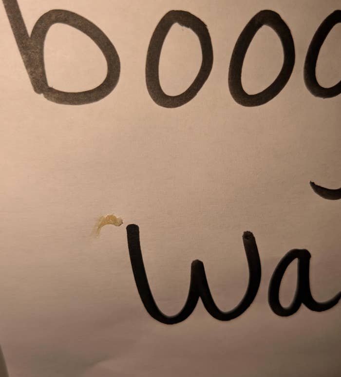 Partial close-up of handwritten text showing &quot;booo&quot; and &quot;wai&quot; on paper