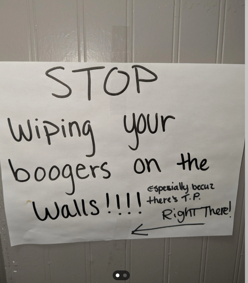 Sign connected  a partition  requesting to halt  wiping boogers, noting there's toilet insubstantial  disposable  nearby