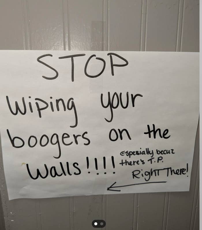 Sign on a wall requesting to stop wiping boogers, noting there&#x27;s toilet paper available nearby