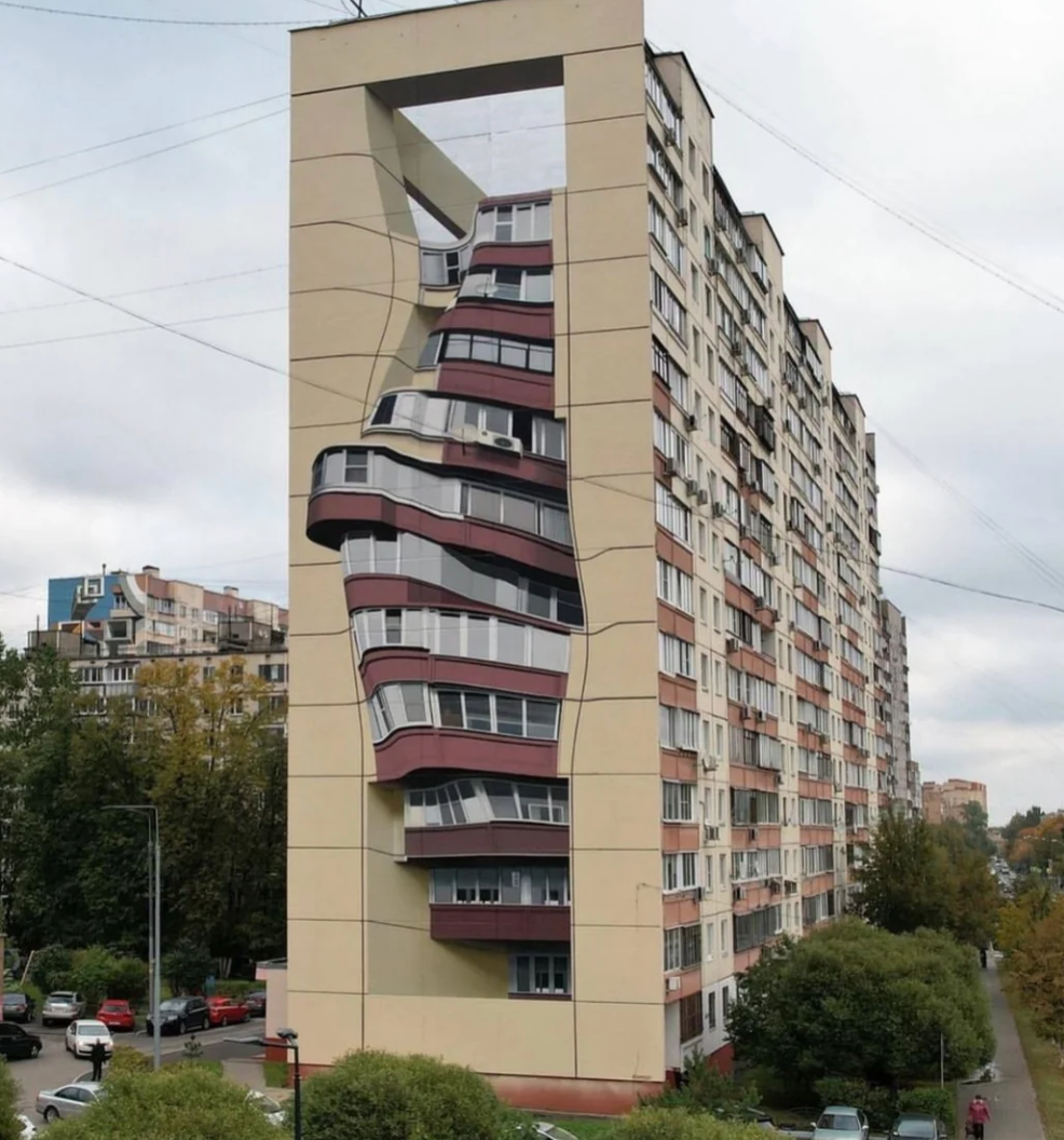 Apartment building with a painted mural creating an optical illusion of warped and twisted floors