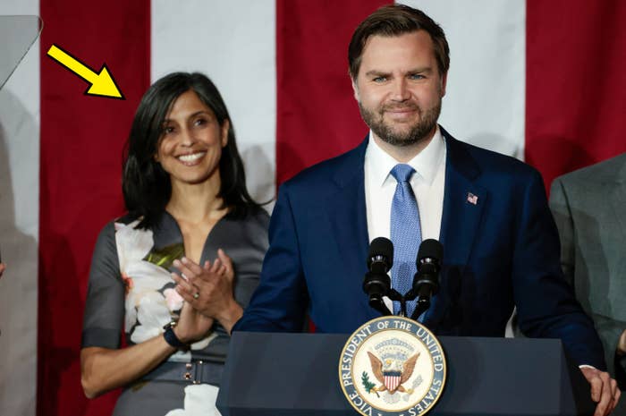 J.D. Vance standing at podium while wife claps and smiles behind him