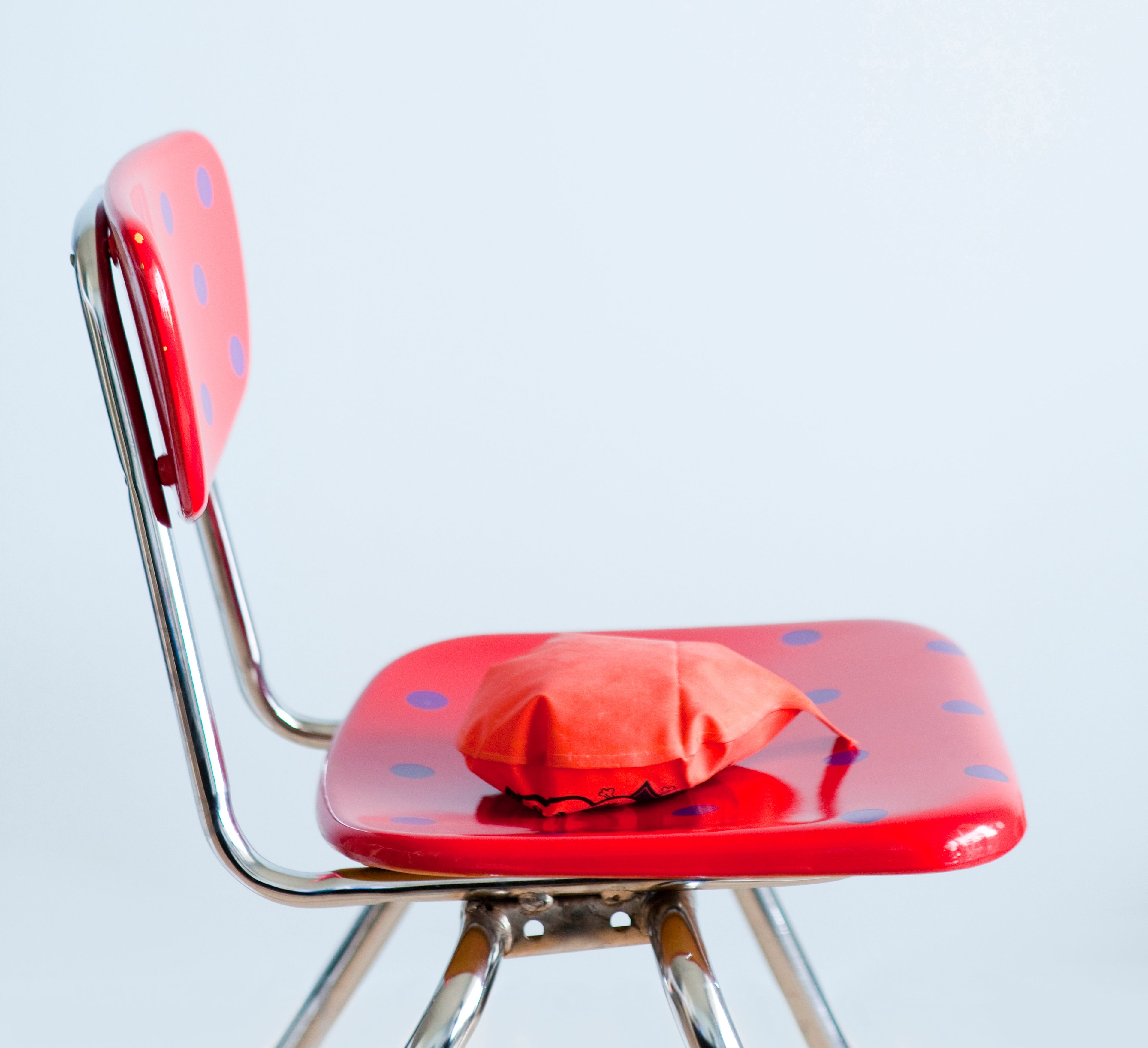 A red chair with a whoopee cushion on the seat