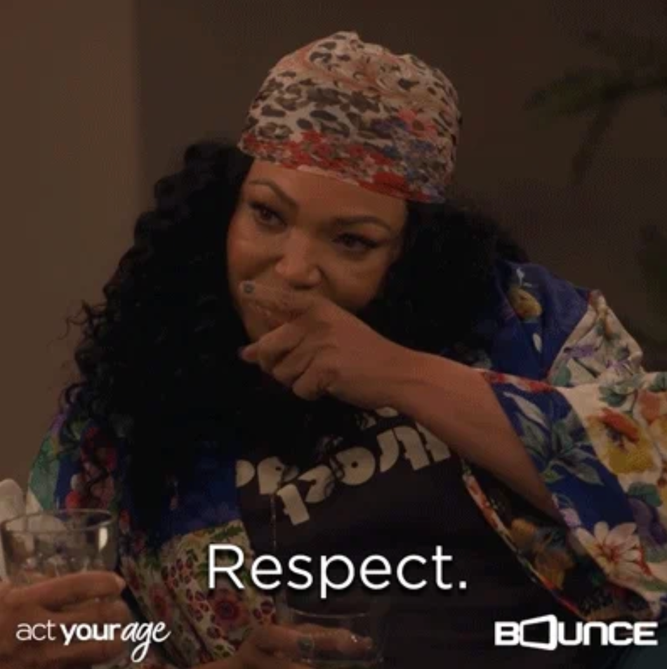 Person in patterned headscarf and floral robe with text overlay: "Respect."