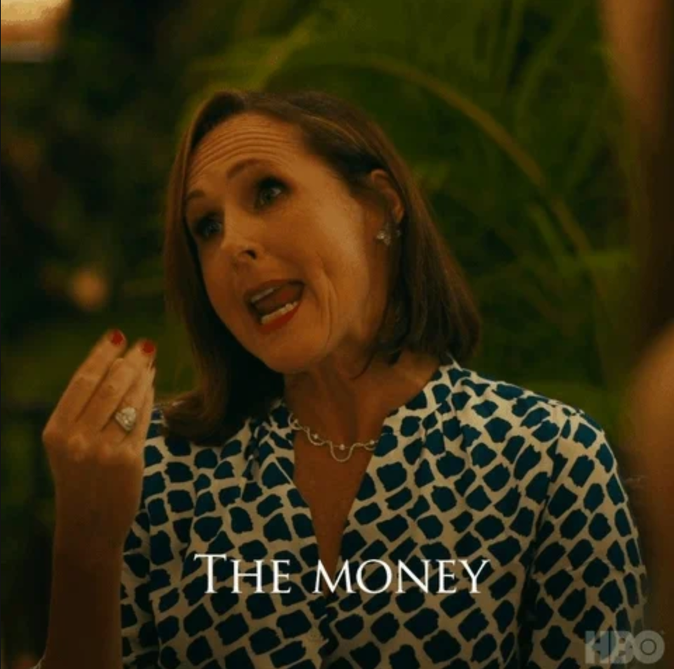 Person gesturing while talking in a patterned blouse, with "The money" text over the image