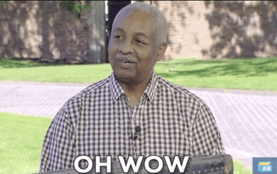 A man with short gray hair holds a keyboard outside, looking amused. The text reads, "OH WOW."