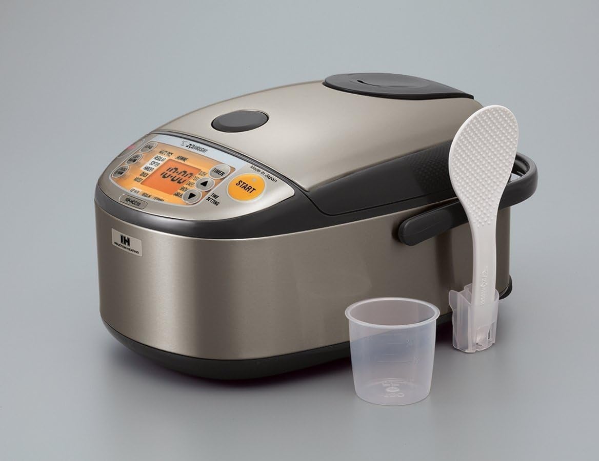 Rice cooker with digital display, spoon, and measuring cup