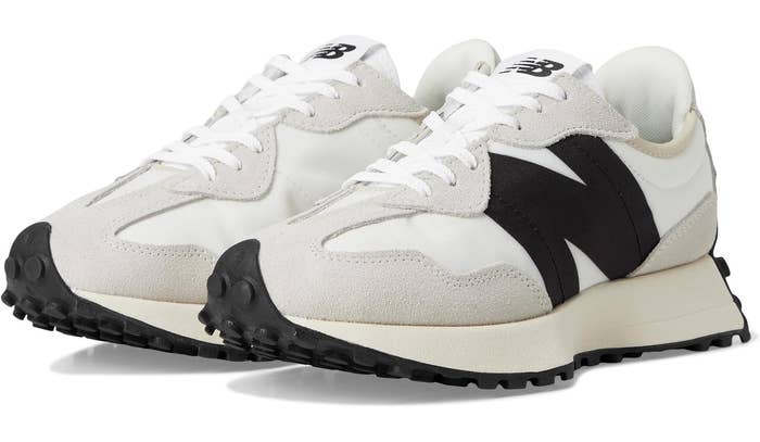 New Balance sneakers with suede accents and ample 'N' logo connected sides, featuring a rugged sole