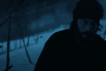 Isaac from &quot;American Primeval&quot; walks through a snowy landscape while carrying a gun