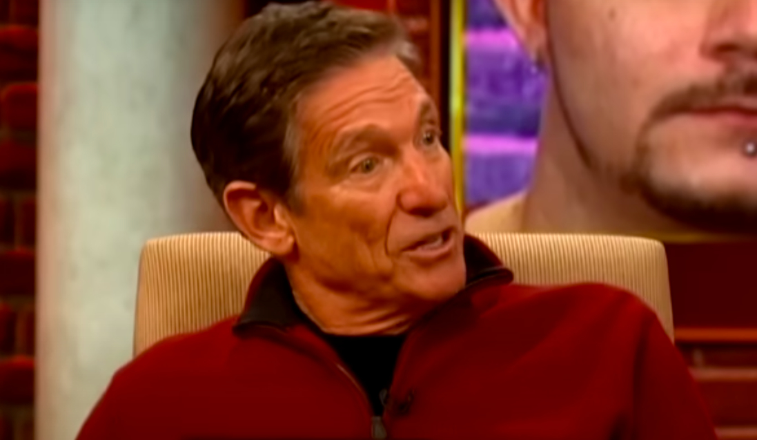 Maury on the couch, ready to reveal the paternity test.