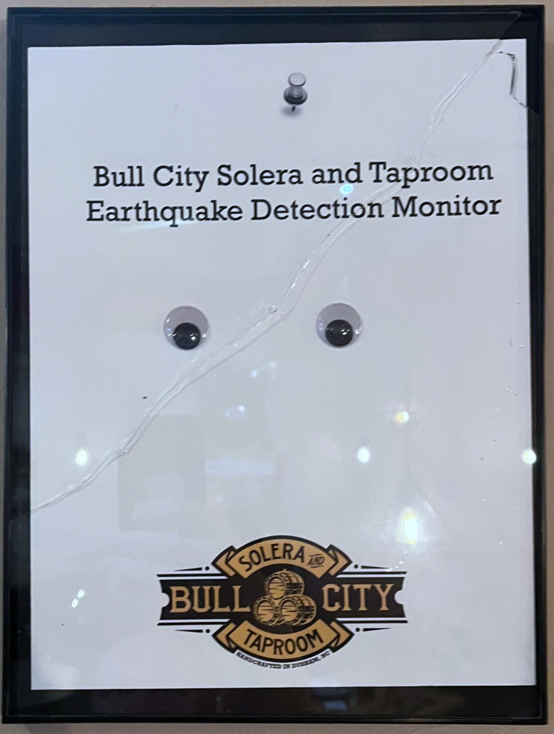  "Bull City Solera and Taproom Earthquake Detection Monitor" with 2  tiny  objects attached. Logo astatine  bottom
