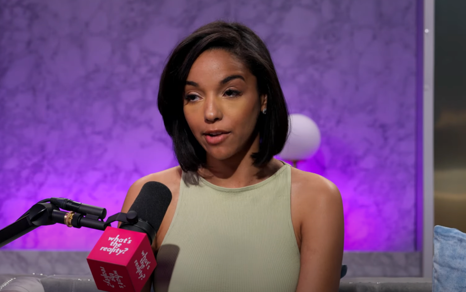 Virginia from "Love Is Blind" speaking into a mic during a podcast appearance