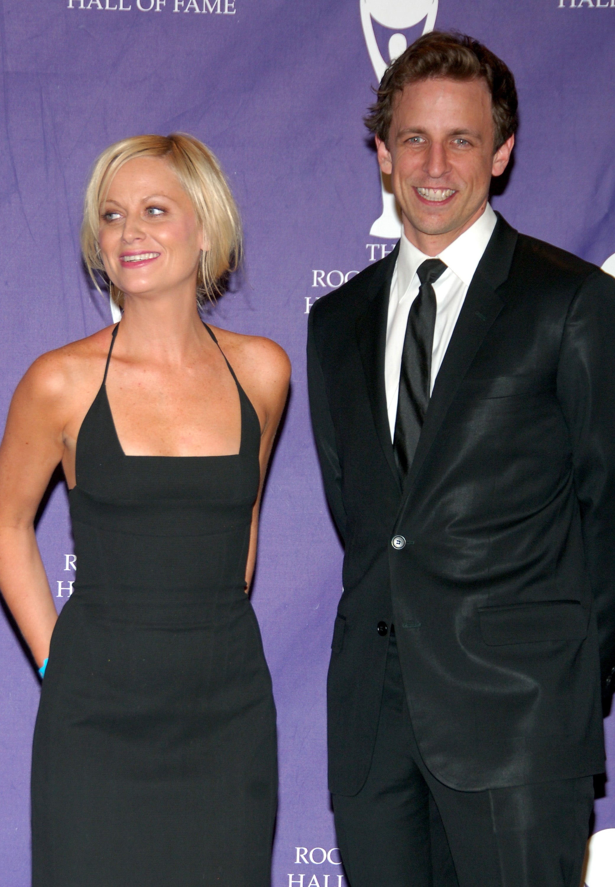 Amy Poehler and Seth Meyers smiling together on the red carpet, 2007