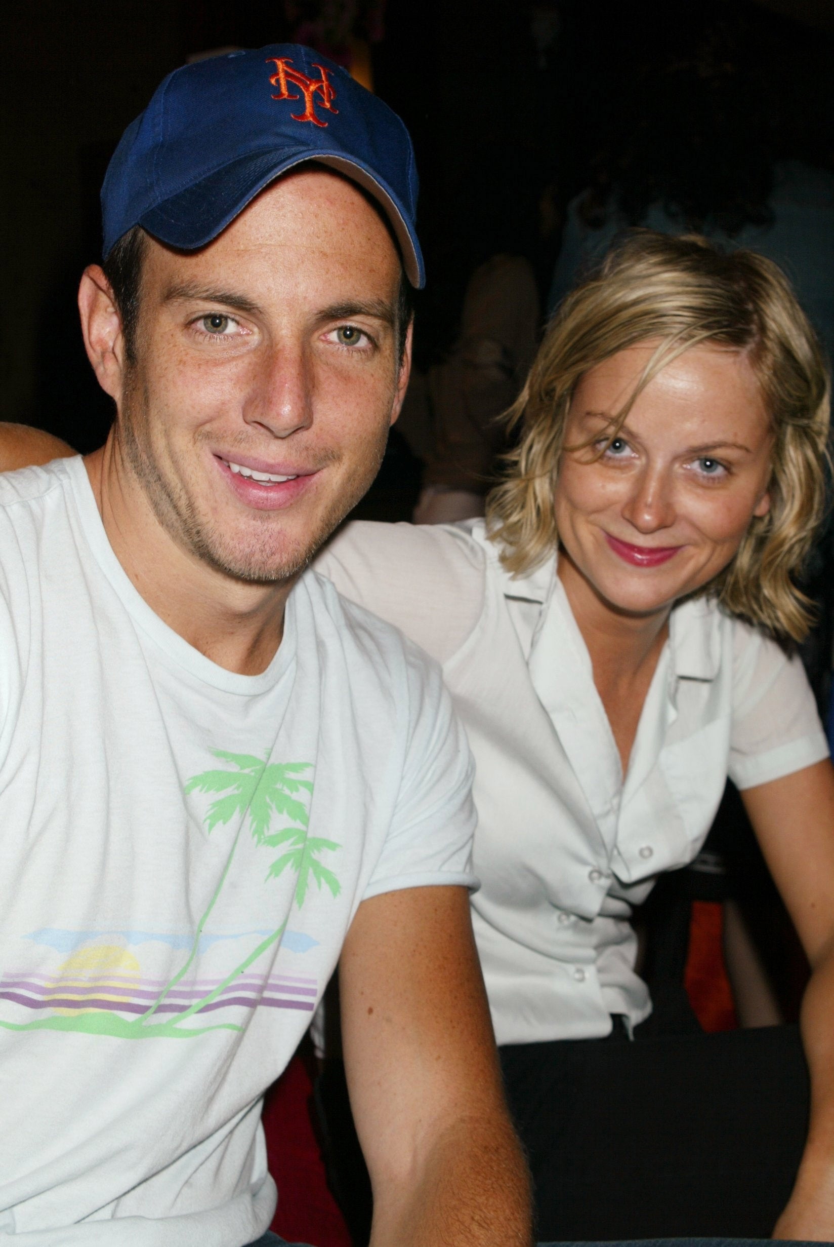 Will Arnett and Amy Poehler sat together smiling, 2004