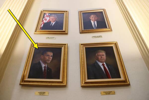Four framed portraits of U.S. presidents are displayed on a wall