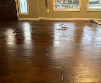 Glossy hardwood floor reflecting light in a home interior, showcasing a sleek finish