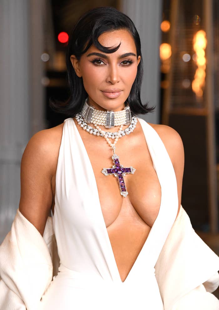 Kim Kardashian posing at an event with hair styled in a sleek bob