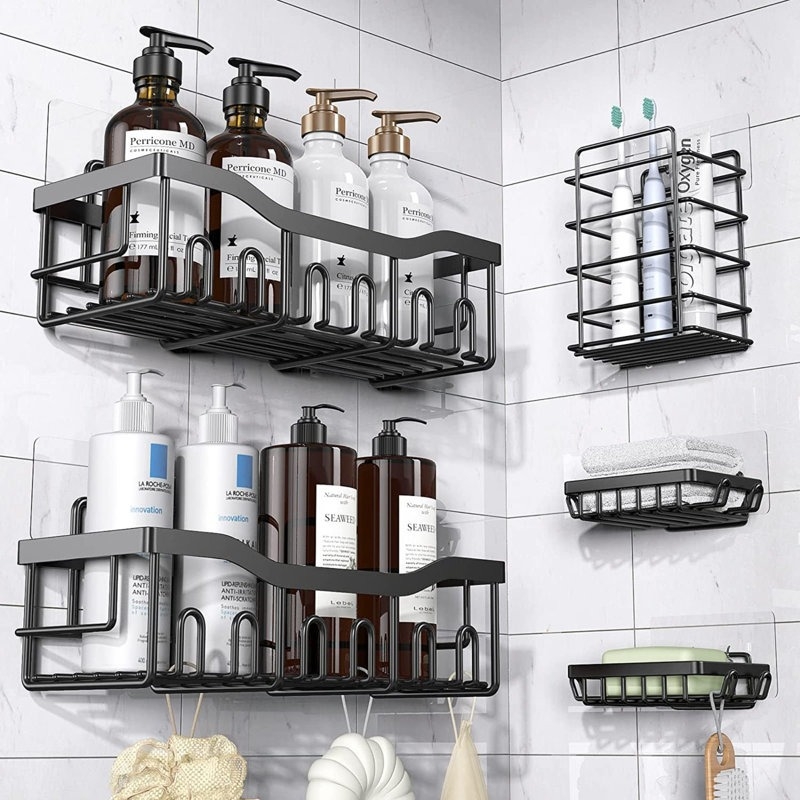 Wall-mounted shower caddy system with shelves holding various bottles of personal care products, soap, brushes, and a shelf for toothbrushes
