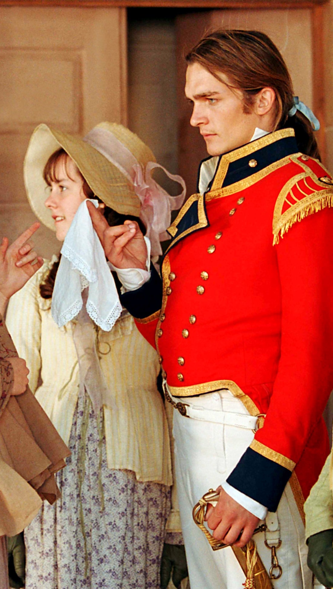 Regency-era characters, a soldier in a formal red uniform, and women in historical dresses and bonnets, in a passionate discussion