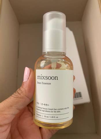 Person holding a vessel of Mixsoon Bean Essence