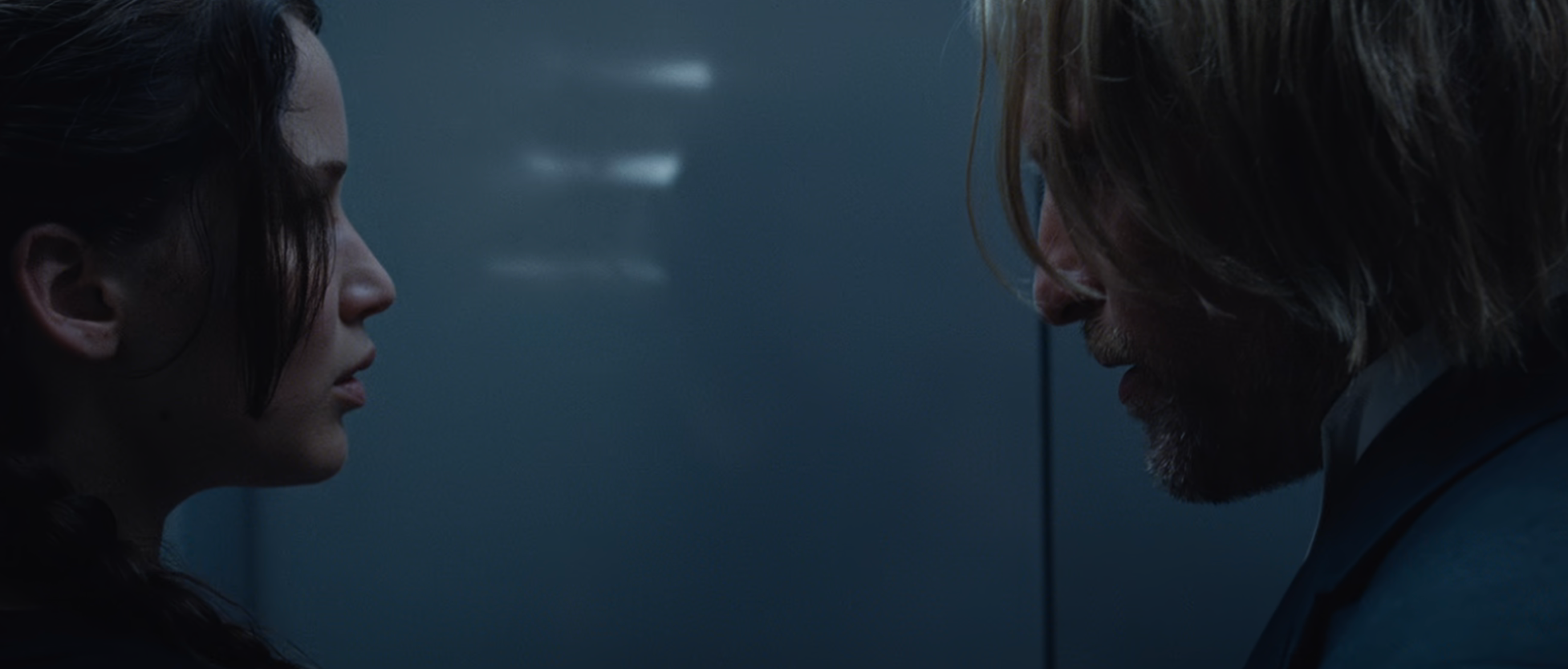 Katniss and Haymitch speaking in a movie scene