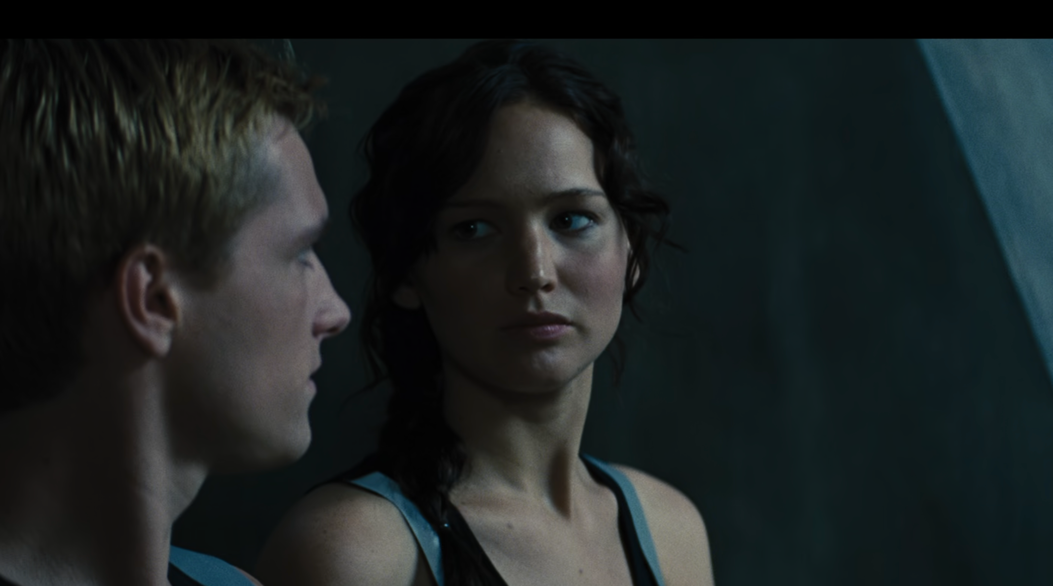 Josh Hutcherson and Jennifer Lawrence as Peeta and Katniss in a scene from "The Hunger Games," looking at each other
