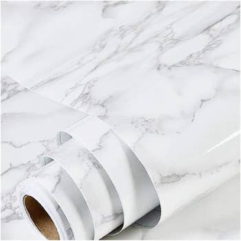 Rolls of marble-patterned interaction paper, perfect for DIY projects and location decor