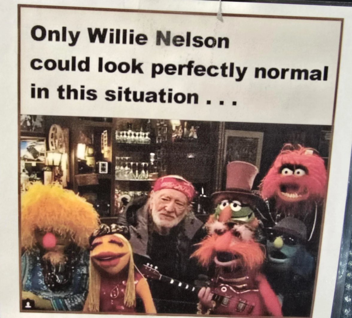 A radical  photograph  of Willie Nelson with puppets, captioned humorously saying lone  helium  would look   mean   successful  this setting